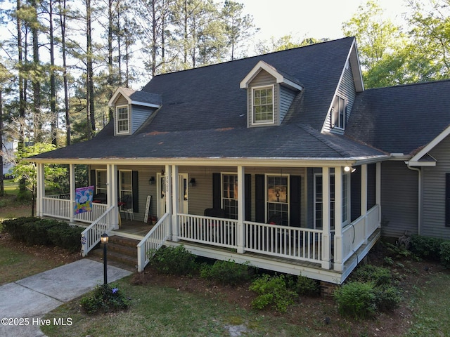 view of front facade featuring a shingled roof and covered porch