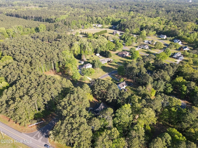 drone / aerial view featuring a forest view