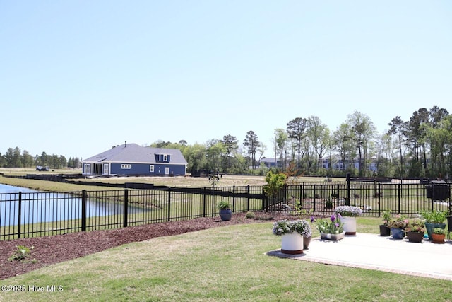 3347 Island Lakes Dr, Oak Island, NC 28461 - view of yard with fence, a water view, and a patio