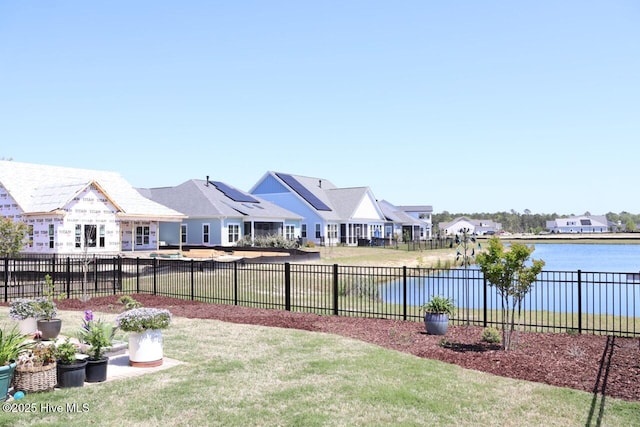 3347 Island Lakes Dr, Oak Island, NC 28461 - view of yard featuring a residential view, a water view, and fence