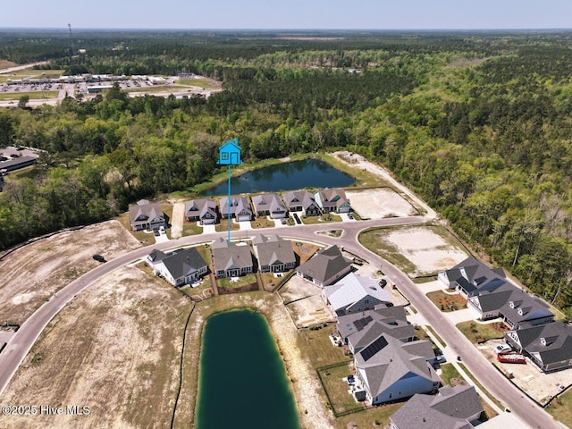 3347 Island Lakes Dr, Oak Island, NC 28461 - drone / aerial view with a view of trees, a residential view, and a water view