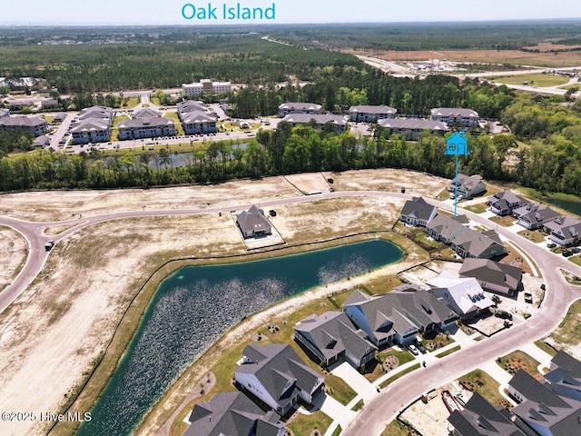 3347 Island Lakes Dr, Oak Island, NC 28461 - bird's eye view featuring a view of trees, a water view, and a residential view