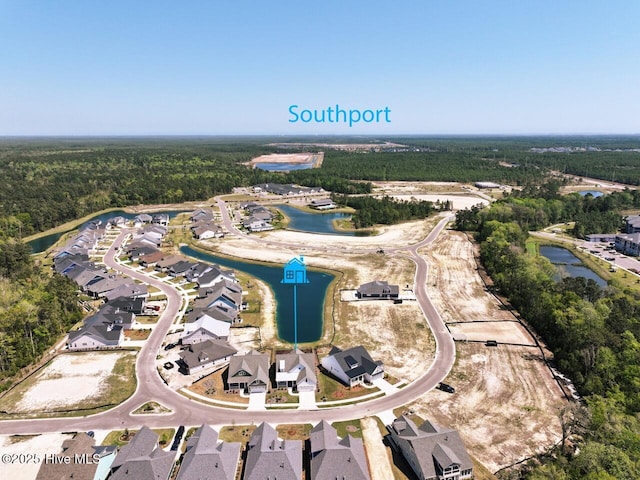 3347 Island Lakes Dr, Oak Island, NC 28461 - aerial view featuring a view of trees and a water view