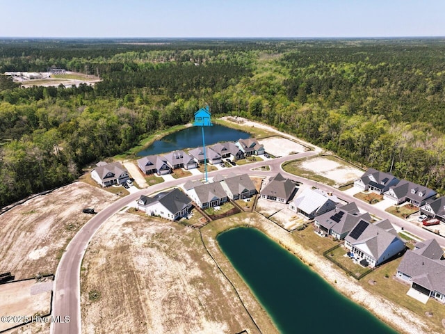 3347 Island Lakes Dr, Oak Island, NC 28461 - birds eye view of property featuring a water view, a residential view, and a wooded view