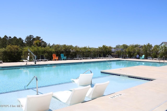 3347 Island Lakes Dr, Oak Island, NC 28461 - pool featuring a patio and fence