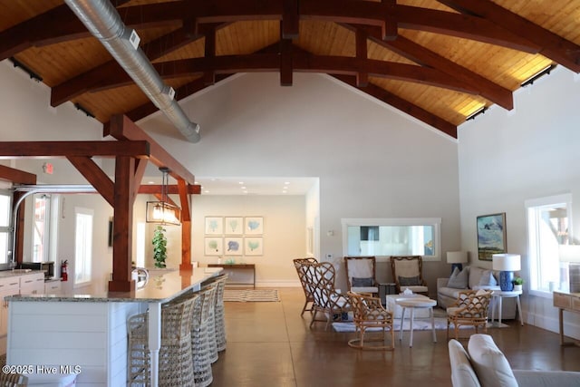 3347 Island Lakes Dr, Oak Island, NC 28461 - living area with beamed ceiling, baseboards, high vaulted ceiling, and wooden ceiling