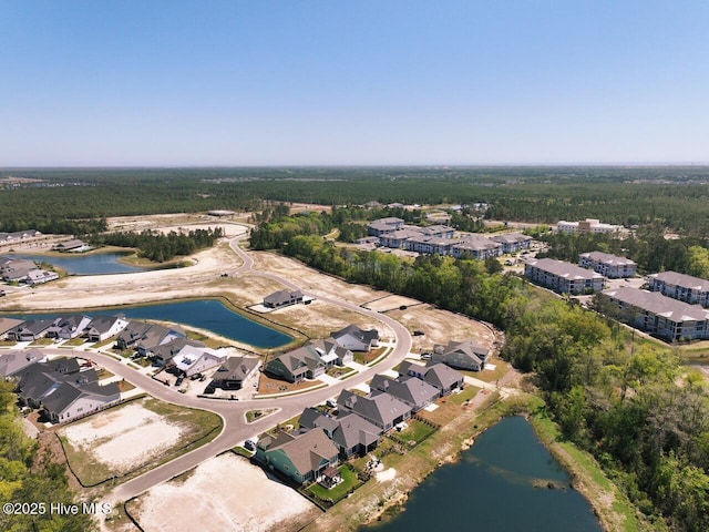 3347 Island Lakes Dr, Oak Island, NC 28461 - drone / aerial view with a residential view, a forest view, and a water view