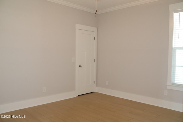 3347 Island Lakes Dr, Oak Island, NC 28461 - empty room with plenty of natural light, baseboards, light wood-style floors, and crown molding