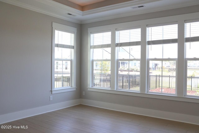 3347 Island Lakes Dr, Oak Island, NC 28461 - spare room with baseboards, crown molding, wood finished floors, and visible vents