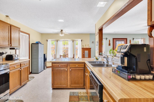 3421 Bethel Rd, Wilmington, NC 28409 - kitchen with a sink, a textured ceiling, stainless steel range with electric cooktop, a peninsula, and black dishwasher