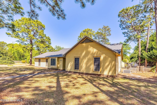 3421 Bethel Rd, Wilmington, NC 28409 - view of front of house with cooling unit, a shingled roof, and fence
