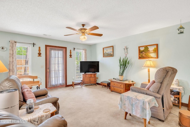 3421 Bethel Rd, Wilmington, NC 28409 - living room with visible vents, light carpet, baseboards, a textured ceiling, and ceiling fan