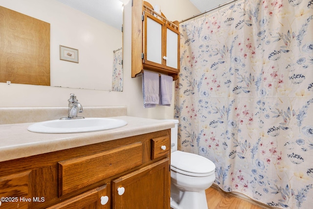 3421 Bethel Rd, Wilmington, NC 28409 - full bath with toilet, a shower with curtain, vanity, and wood finished floors