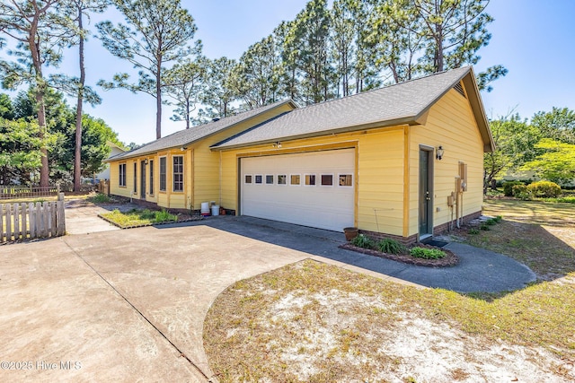 3421 Bethel Rd, Wilmington, NC 28409 - view of front of house with fence, a shingled roof, a garage, and concrete driveway