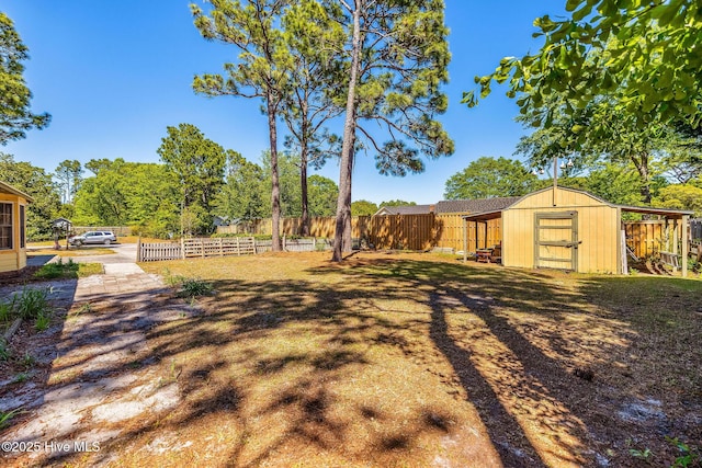 3421 Bethel Rd, Wilmington, NC 28409 - view of yard with an outdoor structure, fence, and a storage shed