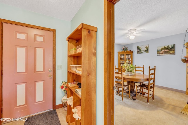 3421 Bethel Rd, Wilmington, NC 28409 - interior space with a textured ceiling, a ceiling fan, baseboards, and light carpet
