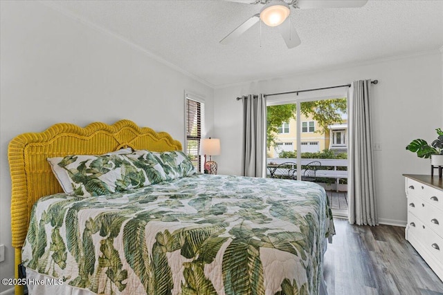7501 E Oak Island Dr, Oak Island, NC 28465 - bedroom featuring access to exterior, a textured ceiling, wood finished floors, and crown molding