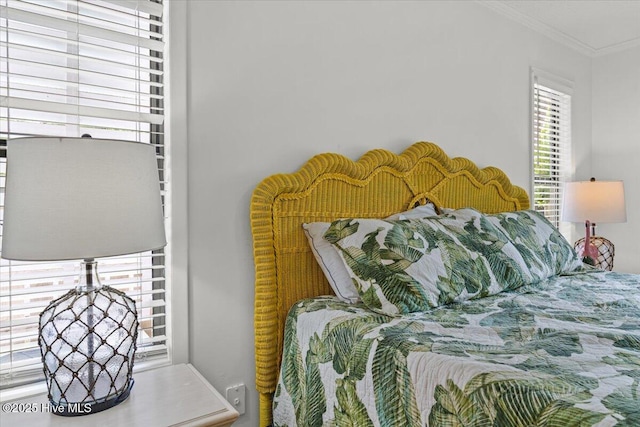 7501 E Oak Island Dr, Oak Island, NC 28465 - bedroom featuring ornamental molding and multiple windows