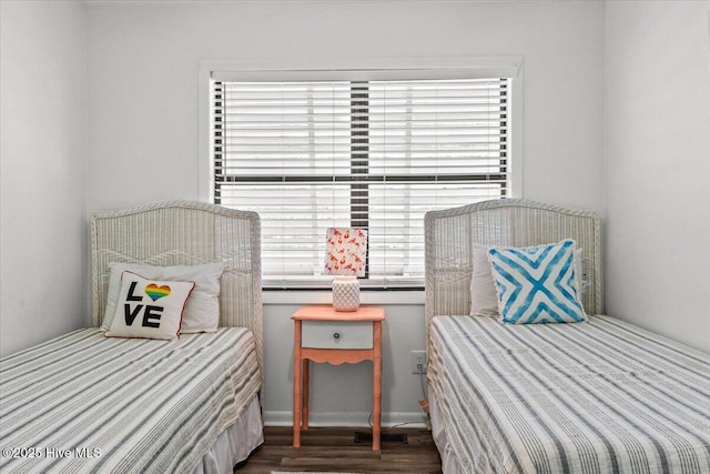 7501 E Oak Island Dr, Oak Island, NC 28465 - bedroom featuring dark wood-style floors