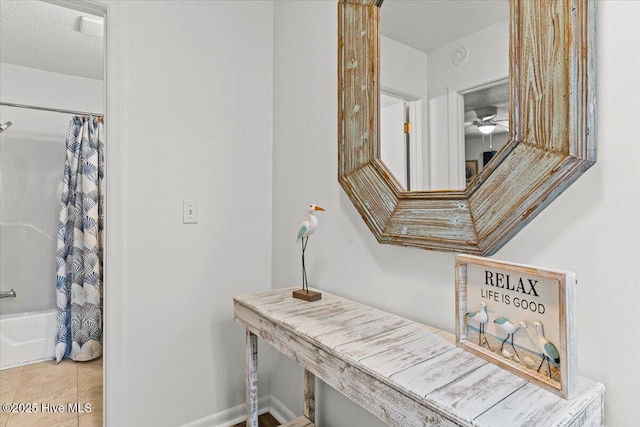 7501 E Oak Island Dr, Oak Island, NC 28465 - interior details with baseboards, a ceiling fan, and a textured ceiling