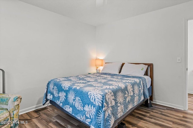 7501 E Oak Island Dr, Oak Island, NC 28465 - bedroom with baseboards and wood finished floors