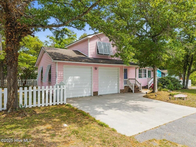 7501 E Oak Island Dr, Oak Island, NC 28465 - traditional-style house featuring driveway, fence, and a garage