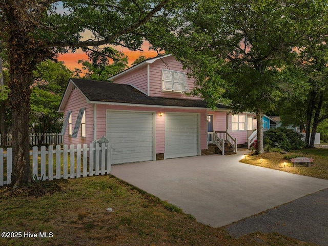 7501 E Oak Island Dr, Oak Island, NC 28465 - exterior space with a garage, fence, and driveway