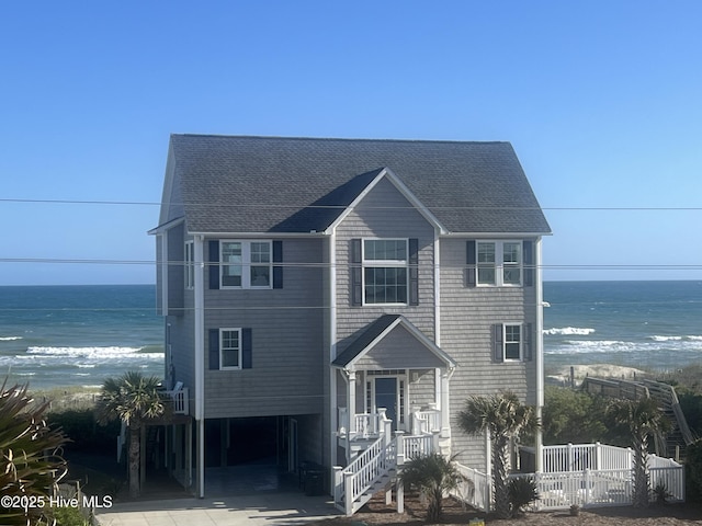 1113 Ocean Dr, Emerald Isle, NC 28594 - coastal home with a water view, fence, and a shingled roof