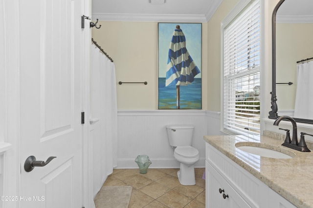 1113 Ocean Dr, Emerald Isle, NC 28594 - full bathroom featuring vanity, tile patterned flooring, crown molding, toilet, and a wainscoted wall