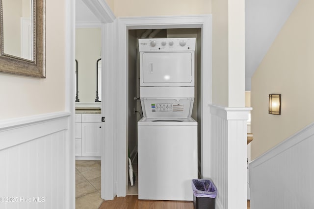 1113 Ocean Dr, Emerald Isle, NC 28594 - washroom featuring stacked washer / drying machine, wainscoting, and laundry area