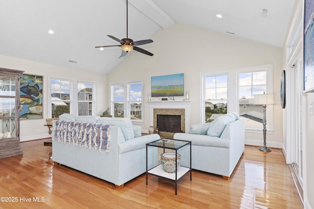 1113 Ocean Dr, Emerald Isle, NC 28594 - living area with ceiling fan, a fireplace, light wood-type flooring, baseboards, and high vaulted ceiling