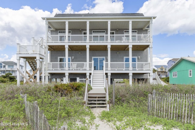 1113 Ocean Dr, Emerald Isle, NC 28594 - view of front of house featuring stairway, fence, and a balcony