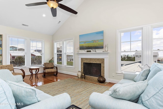 1113 Ocean Dr, Emerald Isle, NC 28594 - living area with ceiling fan, a premium fireplace, high vaulted ceiling, wood finished floors, and visible vents