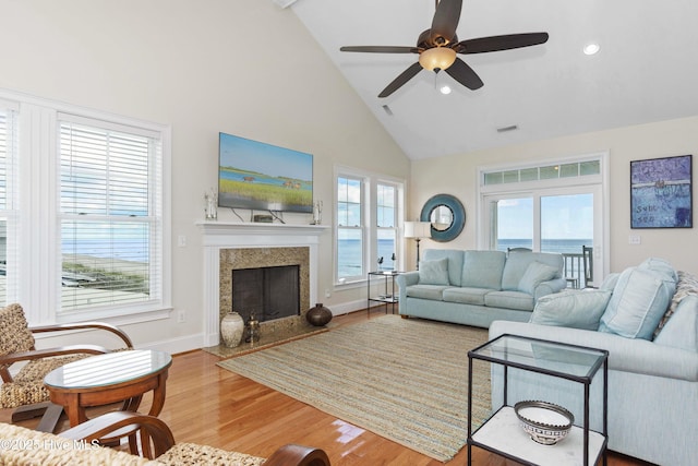 1113 Ocean Dr, Emerald Isle, NC 28594 - living area with a healthy amount of sunlight, high vaulted ceiling, wood finished floors, and visible vents