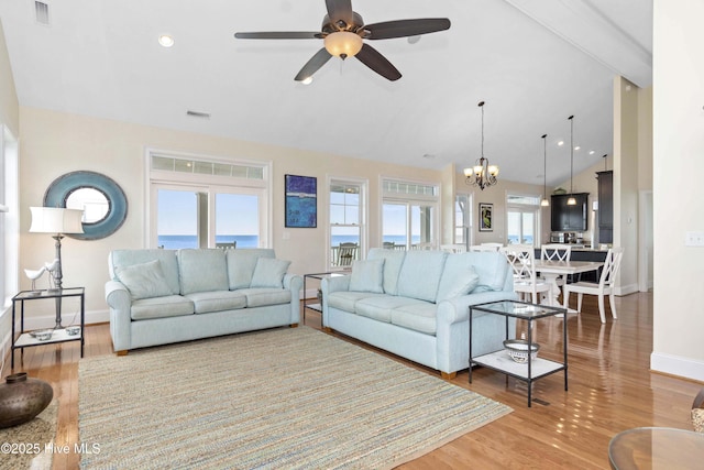 1113 Ocean Dr, Emerald Isle, NC 28594 - living room featuring visible vents, light wood-style flooring, baseboards, and ceiling fan with notable chandelier