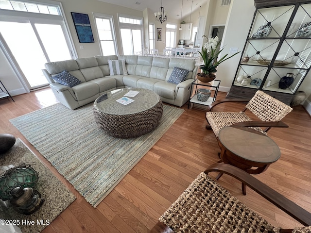1113 Ocean Dr, Emerald Isle, NC 28594 - living area with wood finished floors, a chandelier, and baseboards