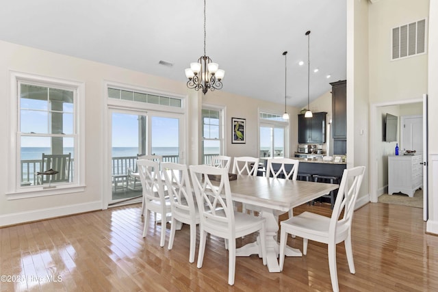 1113 Ocean Dr, Emerald Isle, NC 28594 - dining space with a notable chandelier, baseboards, visible vents, and light wood-type flooring