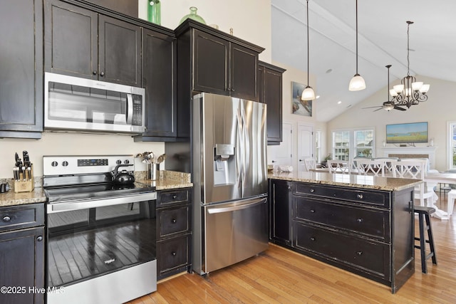 1113 Ocean Dr, Emerald Isle, NC 28594 - kitchen with appliances with stainless steel finishes, a peninsula, open floor plan, lofted ceiling, and light wood-type flooring