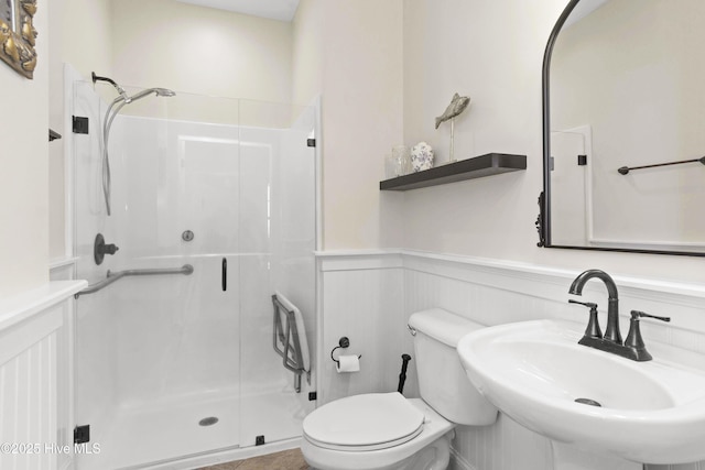 1113 Ocean Dr, Emerald Isle, NC 28594 - bathroom with a sink, a wainscoted wall, and a stall shower
