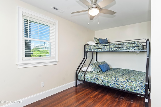 1113 Ocean Dr, Emerald Isle, NC 28594 - bedroom featuring visible vents, baseboards, ceiling fan, and wood finished floors