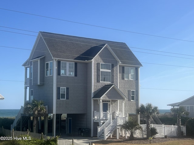 1113 Ocean Dr, Emerald Isle, NC 28594 - raised beach house with fence, stairs, and roof with shingles