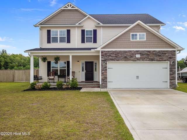 540 Misty Pond Dr, Hubert, NC 28539 - craftsman-style house with covered porch, driveway, stone siding, and roof with shingles