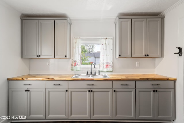 802 2nd St, Elizabeth City, NC 27909 - kitchen featuring a sink, crown molding, gray cabinetry, and wooden counters