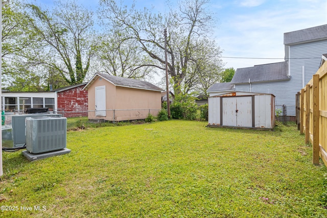 802 2nd St, Elizabeth City, NC 27909 - view of yard with central AC unit, an outbuilding, a shed, and a fenced backyard