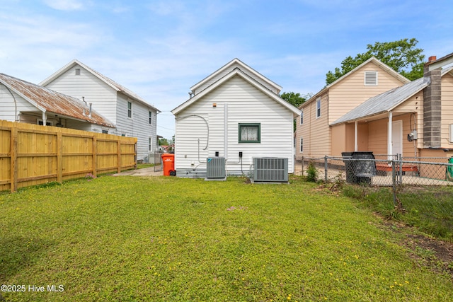 802 2nd St, Elizabeth City, NC 27909 - rear view of house featuring central air condition unit, a yard, and a fenced backyard