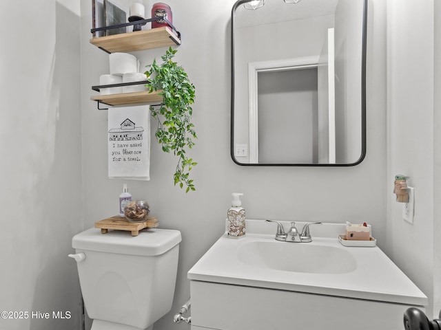 half bathroom featuring toilet and vanity