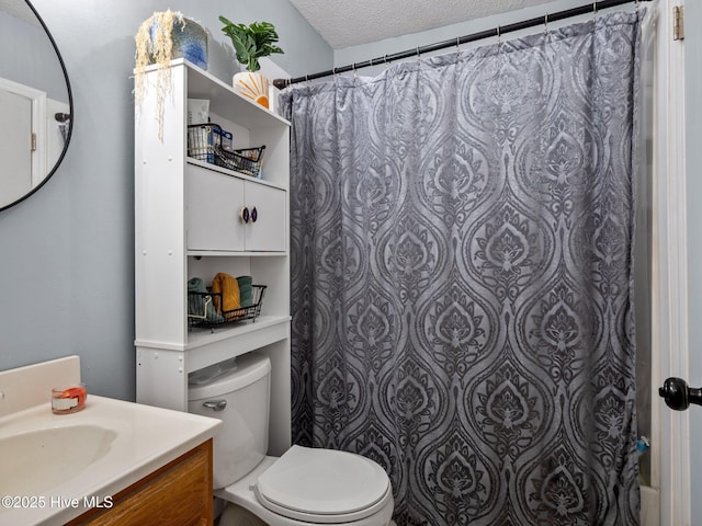 full bathroom with toilet, vanity, a textured ceiling, and curtained shower