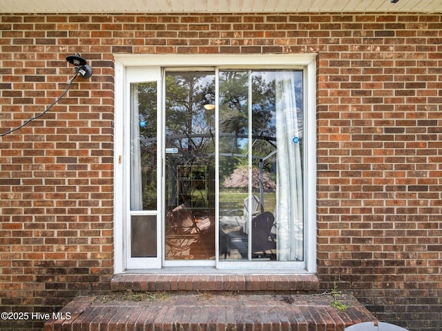 entrance to property with brick siding