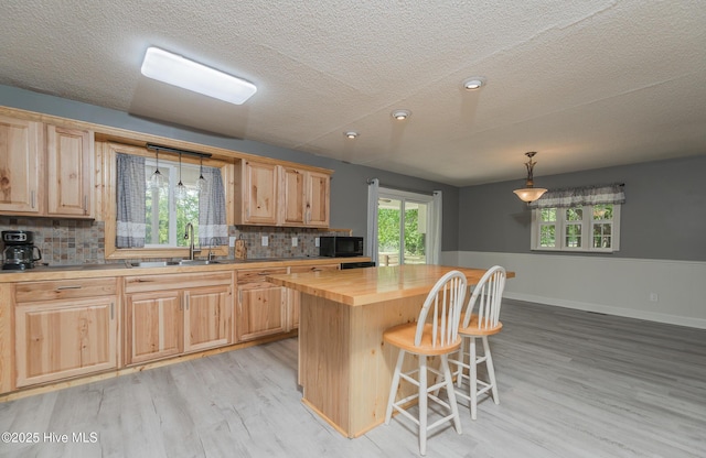 191 Sunset Rd, Wallace, NC 28466 - kitchen featuring a sink, butcher block counters, black microwave, and light brown cabinets