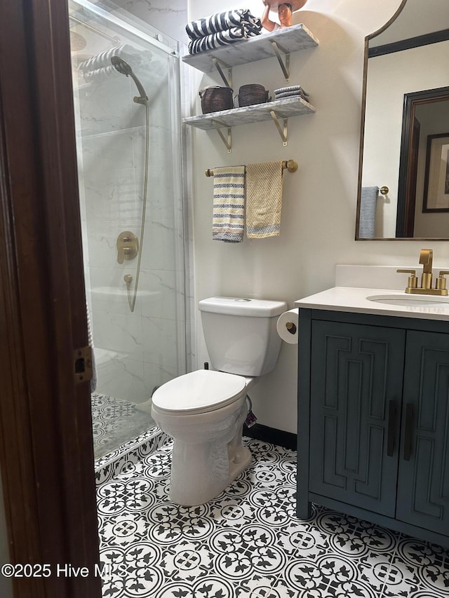 bathroom with a stall shower, toilet, vanity, and baseboards